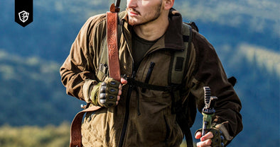 Survivalist man carrying hiking gear