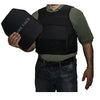 Man wearing a BulletBlocker NIJ IIIA Bulletproof Defender Plus Vest while holding up a hard armor plate