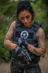 Female model wearing the Legacy Level IIIA Tactical Vest while inspecting a handgun